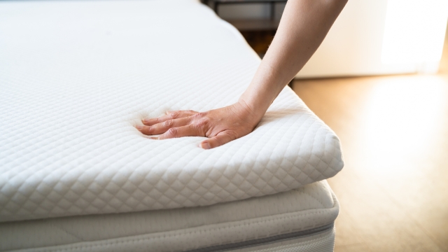 Osoba pritiska površinu dušeka